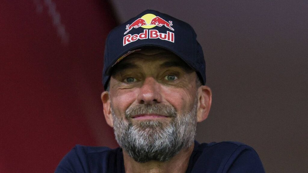 Jurgen Klopp smiling broadly while standing on the touchline
