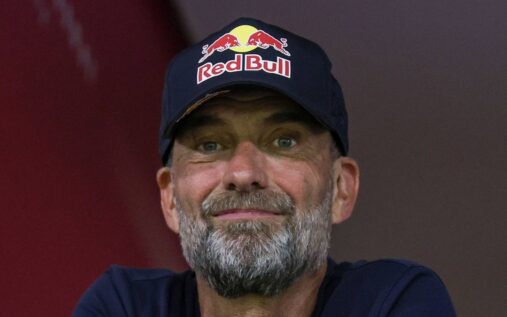 Jurgen Klopp smiling broadly while standing on the touchline