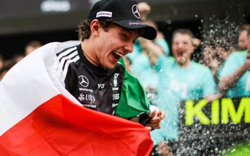 Mercedes Formula 1 driver Kimi Antonelli wearing his race suit and helmet while celebrating a grand prix victory