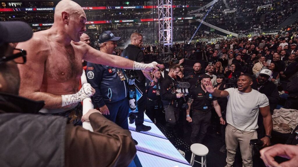 Anthony Joshua standing in a boxing ring looking focused ahead of his upcoming heavyweight fight.