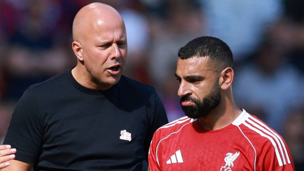 Mohamed Salah looking visibly frustrated on the pitch while wearing a Liverpool kit