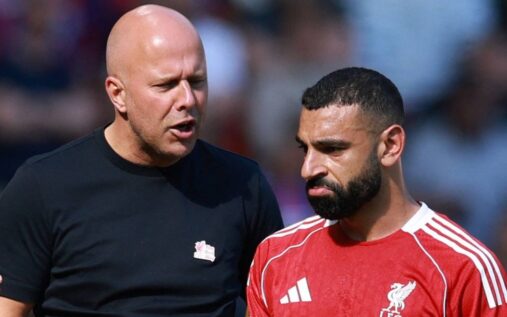 Mohamed Salah looking visibly frustrated on the pitch while wearing a Liverpool kit