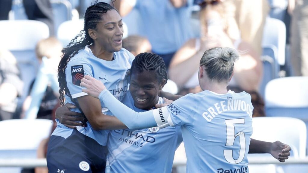 Manchester City players celebrating winning the Women's Super League title