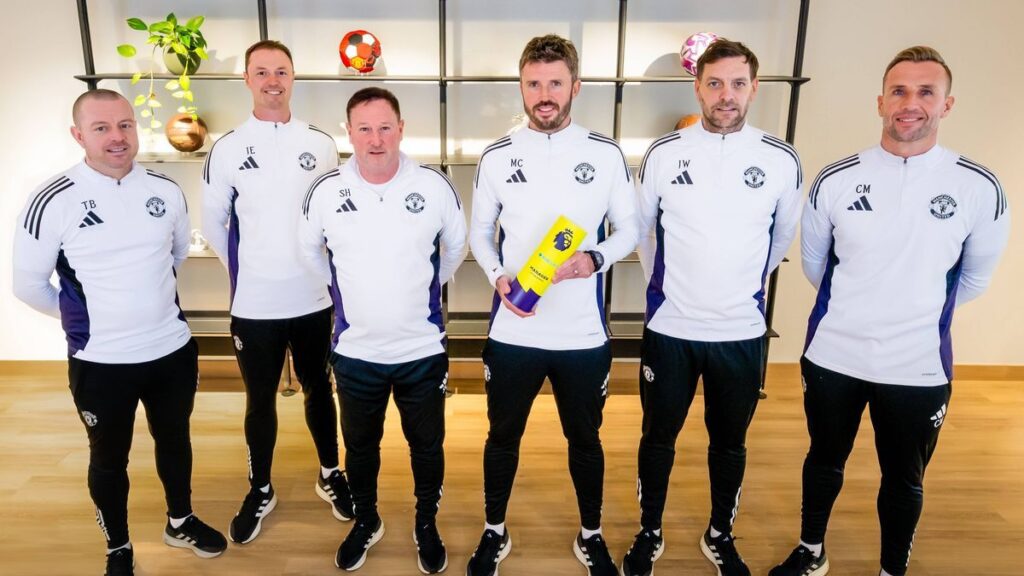 Michael Carrick standing on the touchline managing Manchester United