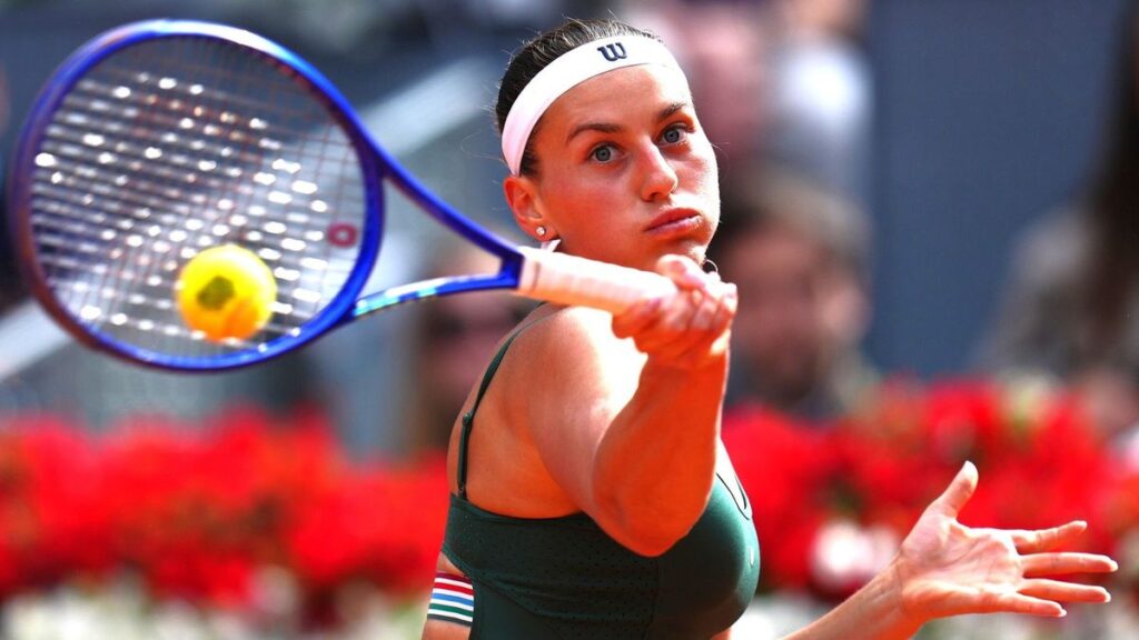 Marta Kostyuk performing a celebratory backflip on the clay court after winning the Madrid Open final