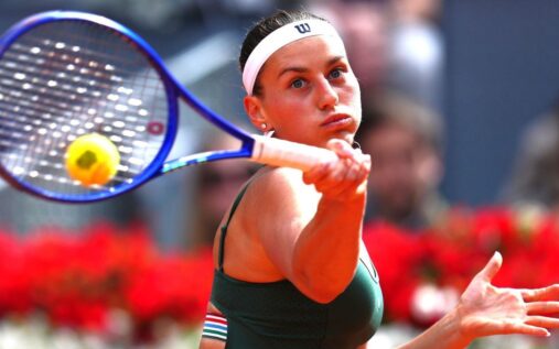 Marta Kostyuk performing a celebratory backflip on the clay court after winning the Madrid Open final