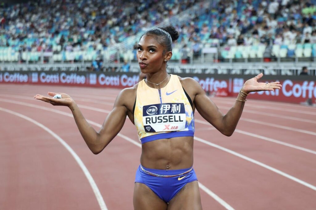 Masai Russell sprinting on the track during the women's 100m hurdles event