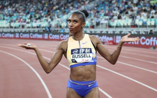 Masai Russell sprinting on the track during the women's 100m hurdles event