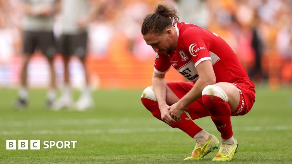 Dejected Middlesbrough players on the Wembley pitch after losing the play-off final to Hull City