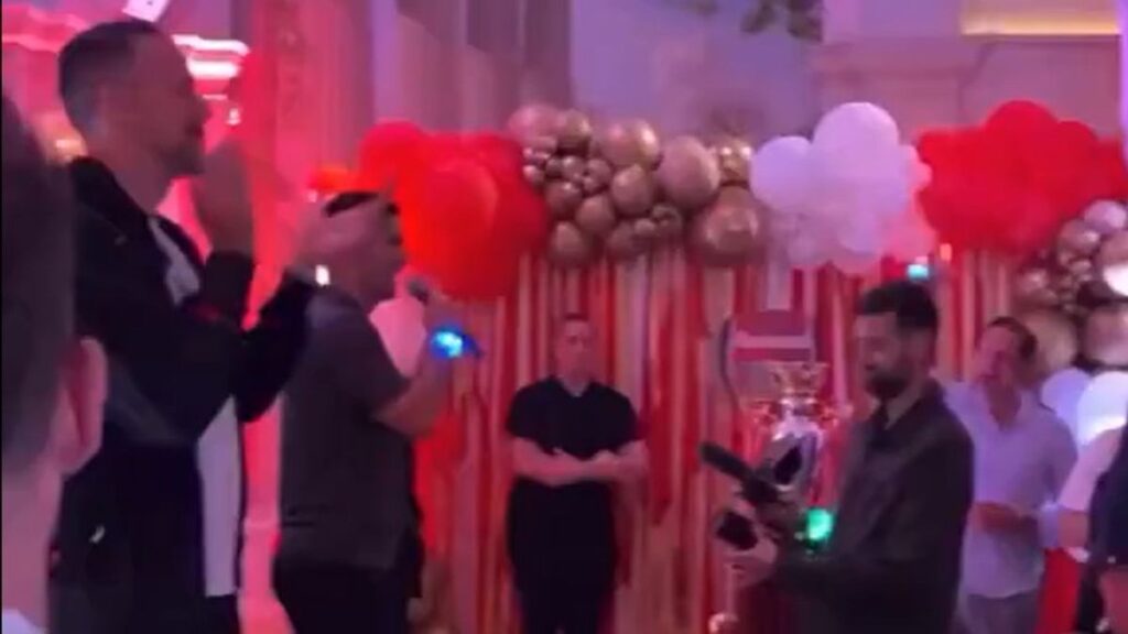 Mikel Arteta addressing Arsenal fans with a microphone during Premier League title celebrations