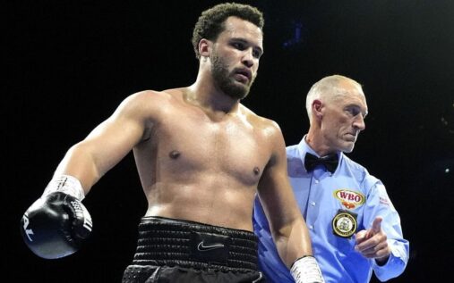 Moses Itauma posing with boxing gloves inside the ring