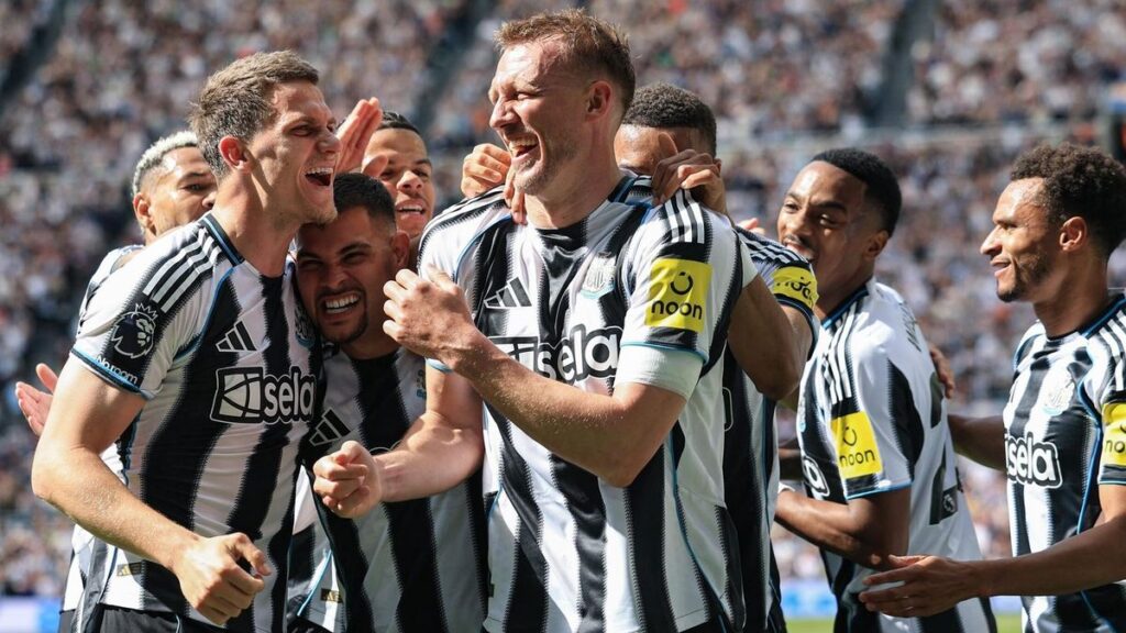 Newcastle United players celebrating a goal against Brighton at St James' Park
