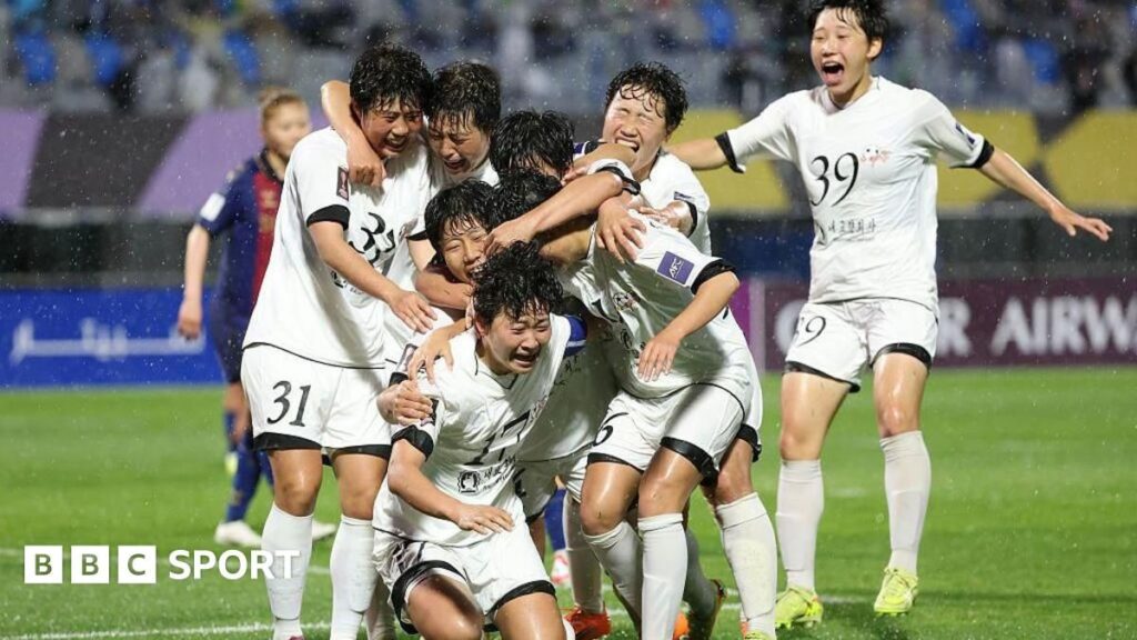 North Korean football players from Naegohyang celebrating their 2-1 victory on the pitch