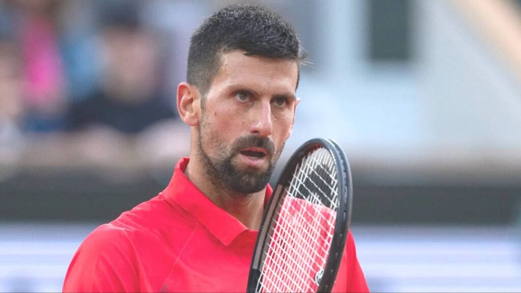 Novak Djokovic speaking into a microphone at a French Open press conference