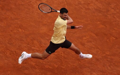 Novak Djokovic preparing to hit a forehand during a clay-court tennis match at the French Open
