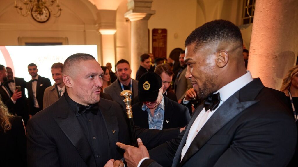 Oleksandr Usyk and Anthony Joshua embrace in the boxing ring