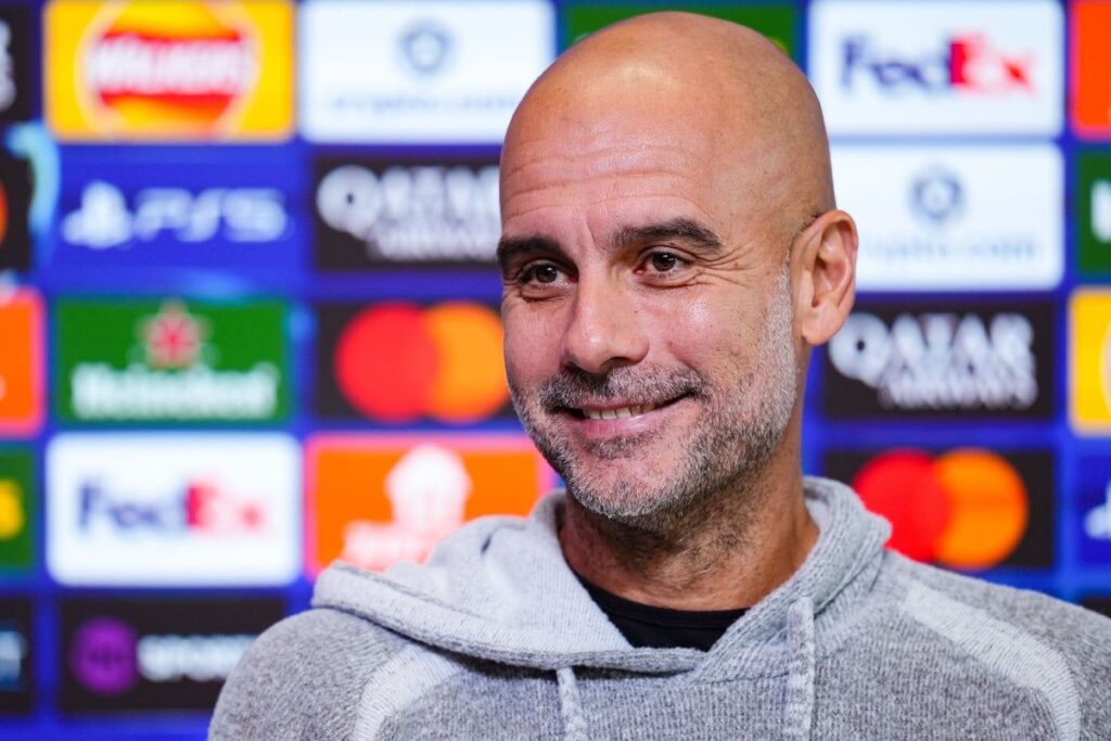 Pep Guardiola gesturing on the touchline during a Manchester City Premier League match