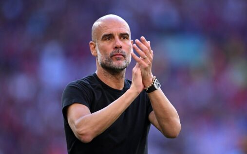 Manchester City manager Pep Guardiola standing on the touchline looking thoughtful