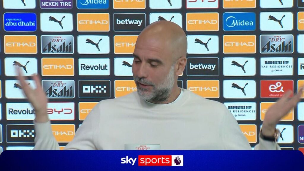 Pep Guardiola watching a football match from the stadium stands