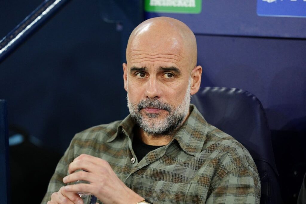 Manchester City manager Pep Guardiola standing on the touchline during a Champions League match against Real Madrid