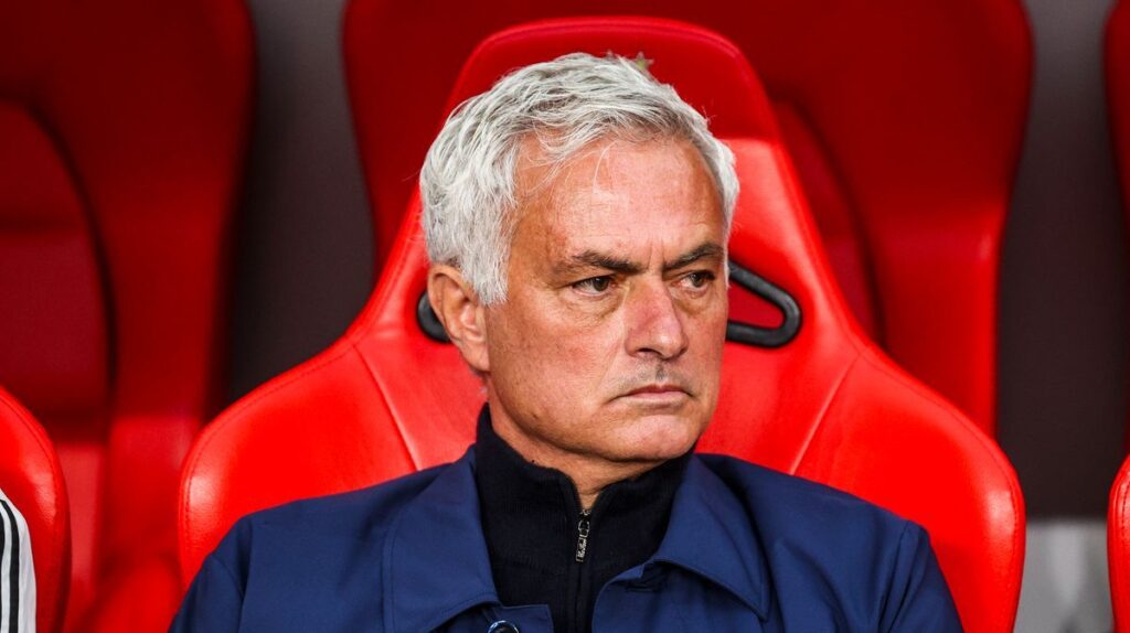 Jose Mourinho looking serious on the touchline while managing in a suit