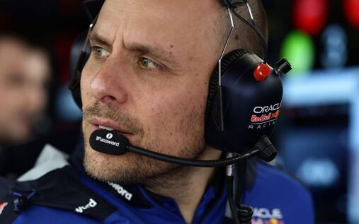 Gianpiero Lambiase wearing a Red Bull racing headset looking thoughtfully at a monitor in the Formula 1 paddock