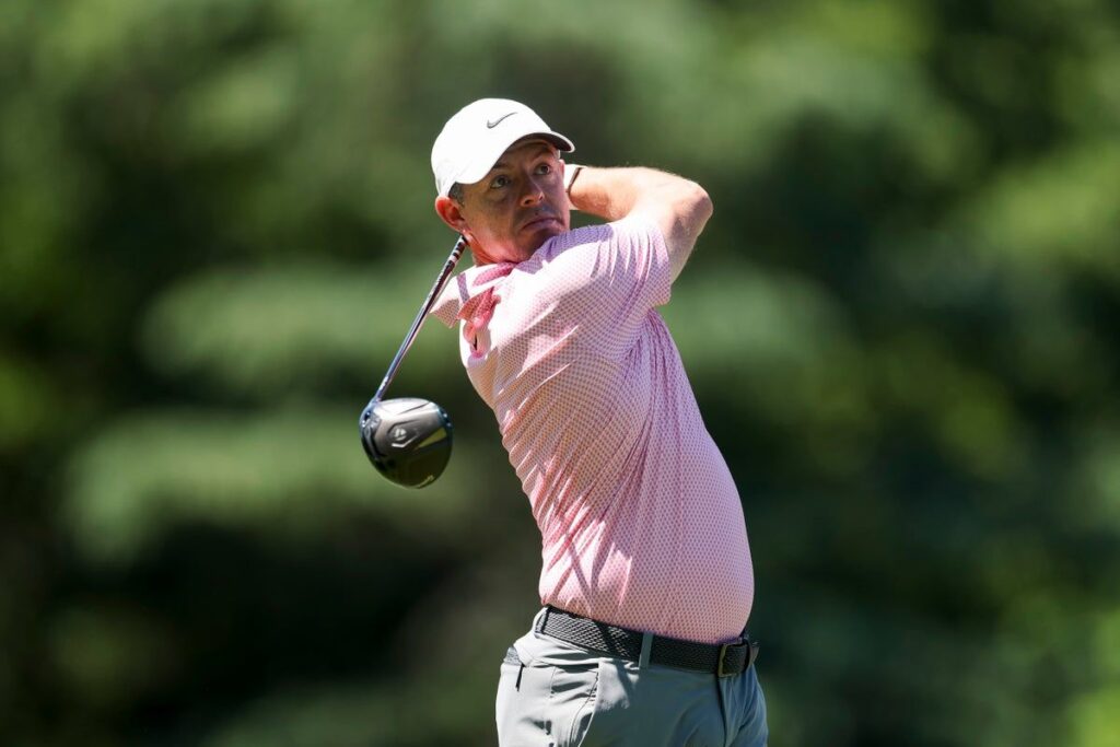 Rory McIlroy smiling and waving to the crowd during a professional golf tournament