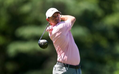 Rory McIlroy smiling and waving to the crowd during a professional golf tournament