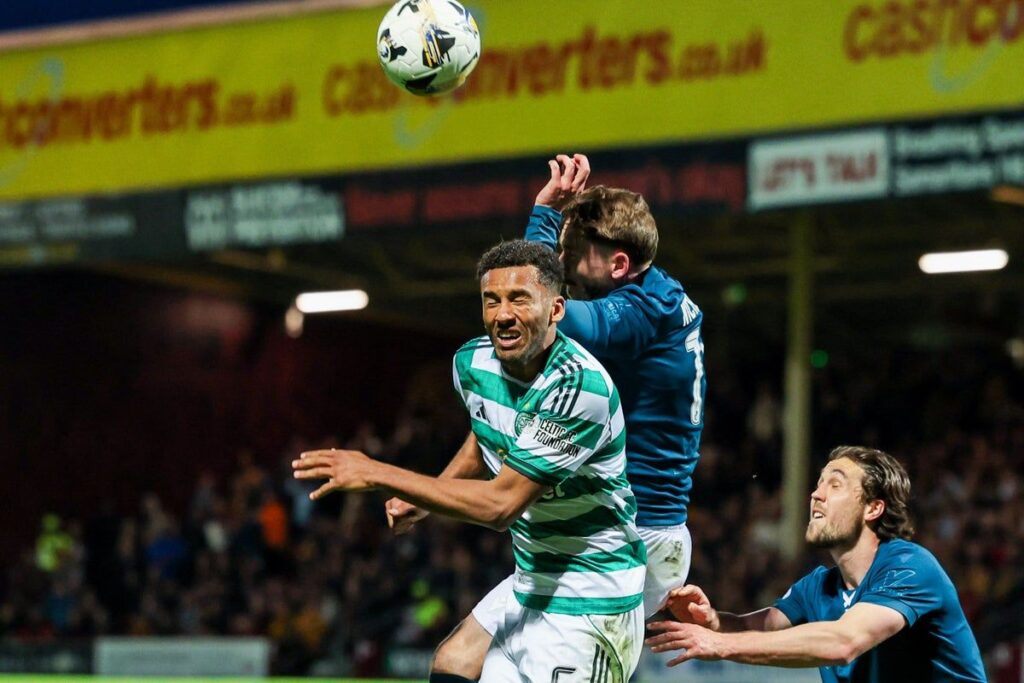 Referee pointing to the penalty spot during a Scottish Premiership match