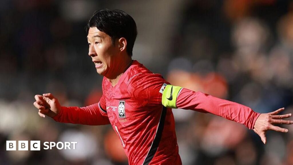 South Korea captain Son Heung-min applauding the fans while wearing the national team kit