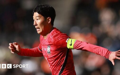 South Korea captain Son Heung-min applauding the fans while wearing the national team kit