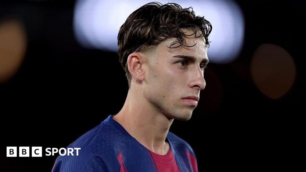 Fermin Lopez looking dejected on the pitch in a Spain national team kit