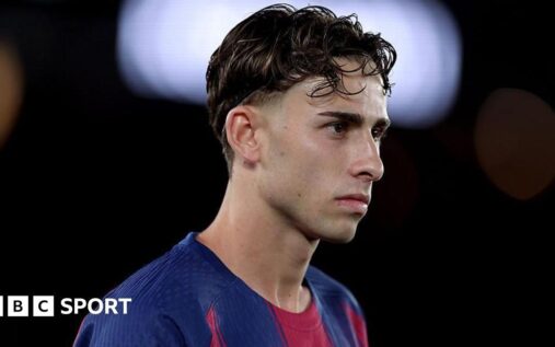 Fermin Lopez looking dejected on the pitch in a Spain national team kit