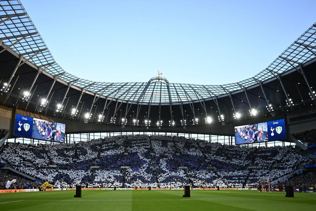 Tottenham Hotspur fans holding protest banners in the stands during a Premier League match