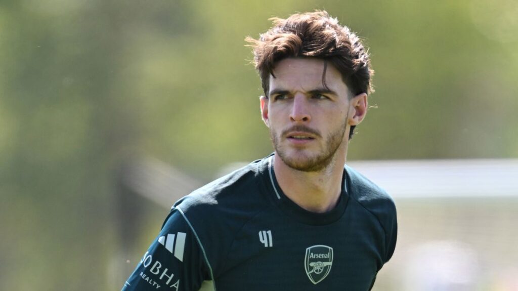 Declan Rice looking visibly frustrated on the pitch during an Arsenal Champions League match.