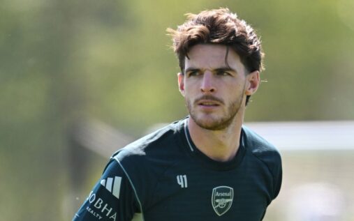 Declan Rice looking visibly frustrated on the pitch during an Arsenal Champions League match.