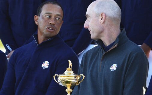 Jim Furyk and Tiger Woods conversing on a golf course during a previous Ryder Cup tournament