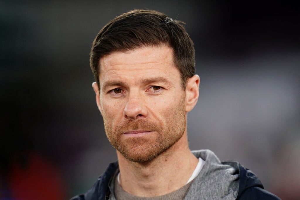 Xabi Alonso looking thoughtful on the touchline during a match