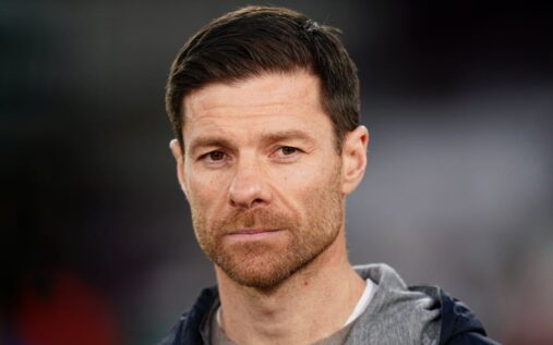 Xabi Alonso looking thoughtful on the touchline during a match