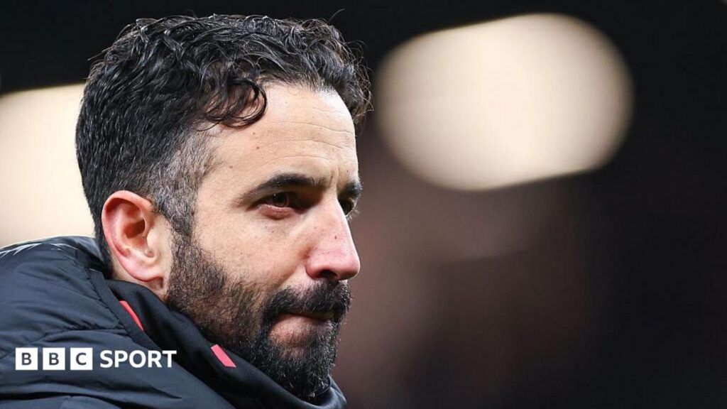 Ruben Amorim standing on the touchline wearing a dark suit
