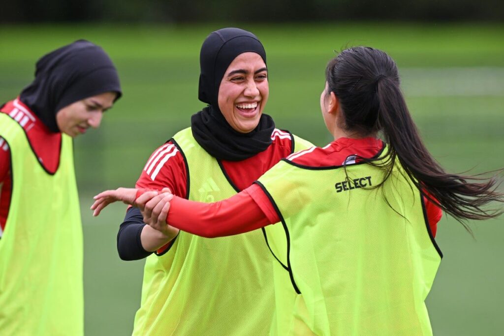 The Afghan women's football team training together on a pitch