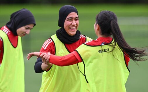 The Afghan women's football team training together on a pitch
