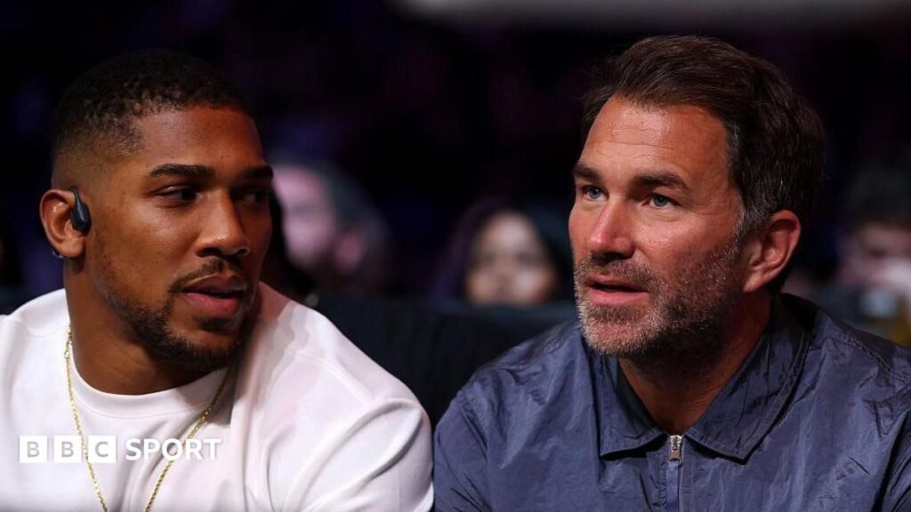 Anthony Joshua and Tyson Fury facing off inside a boxing ring