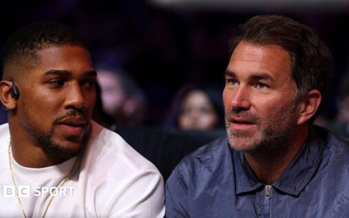 Anthony Joshua and Tyson Fury facing off inside a boxing ring