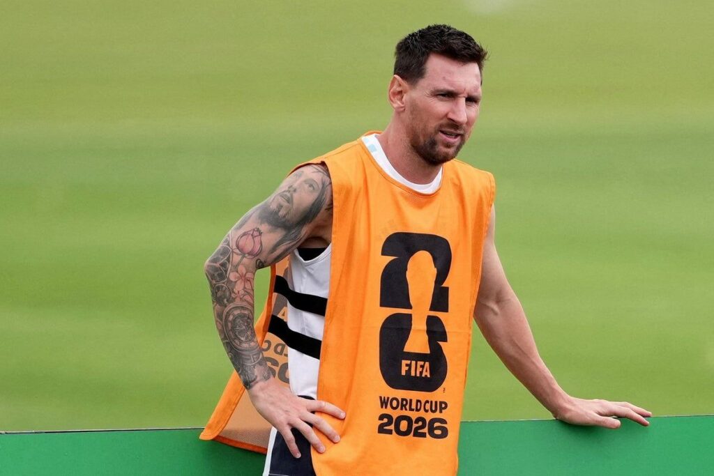 Argentina captain Lionel Messi looking thoughtful on the pitch wearing the national team kit
