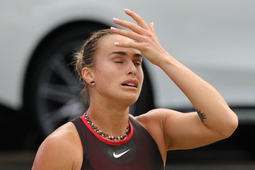 Aryna Sabalenka looking dejected on the tennis court during a match