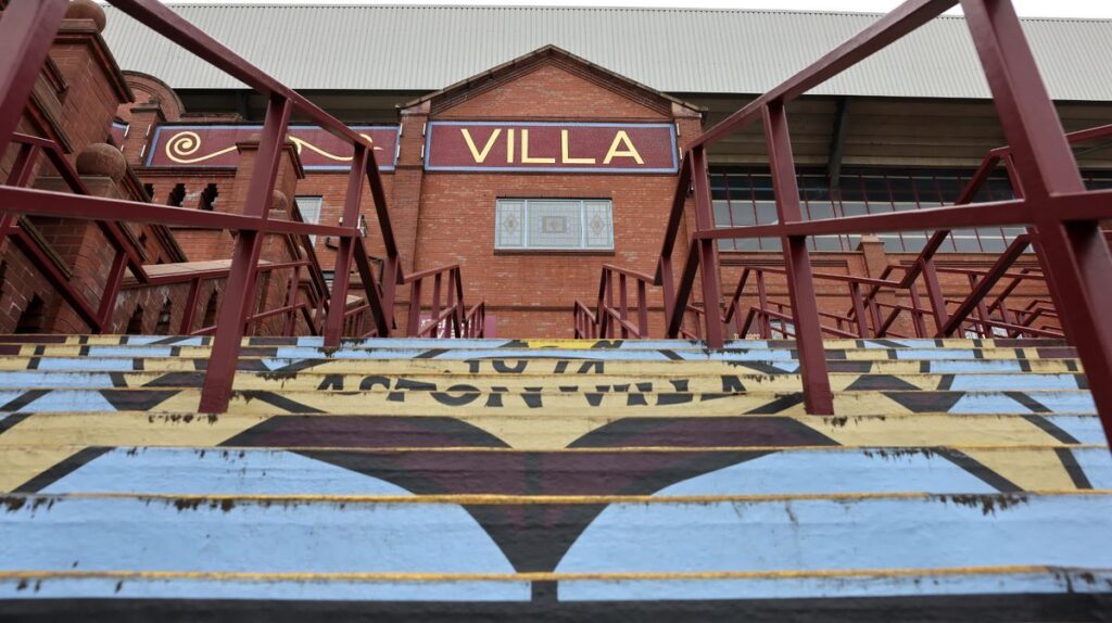 Aston Villa players standing on the pitch waiting for a Premier League match to kick off