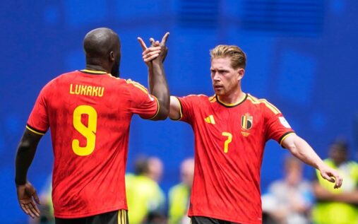 A dejected Kevin De Bruyne and Romelu Lukaku walking on the pitch in Belgium national team kits