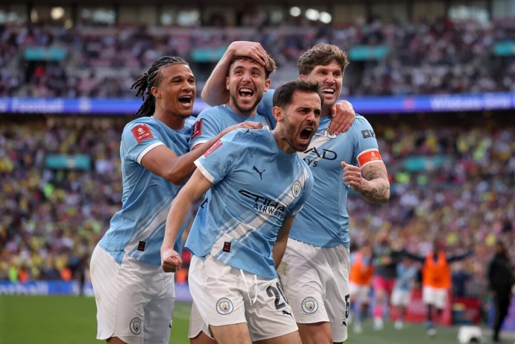 Bernardo Silva wearing the Manchester City captain's armband looking thoughtful on the pitch
