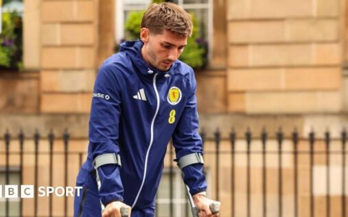 Scotland midfielder Billy Gilmour looking dejected on the pitch before his World Cup injury withdrawal